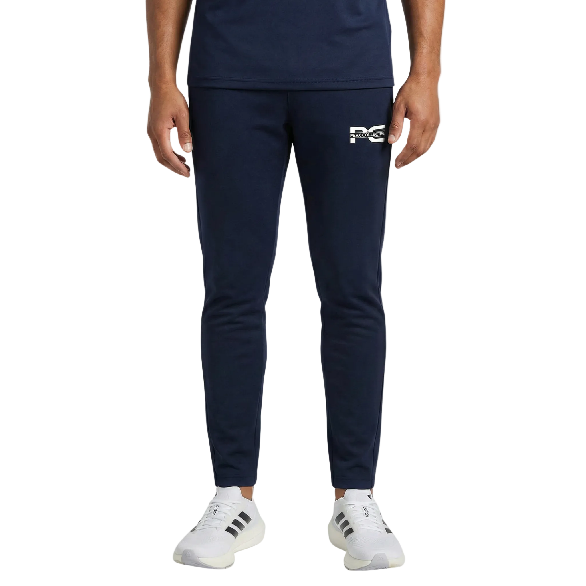 Man wearing AeroJogger men’s slim fit navy jogger pants with logo, standing on a light grey background, styled for casual and streetwear fashion.