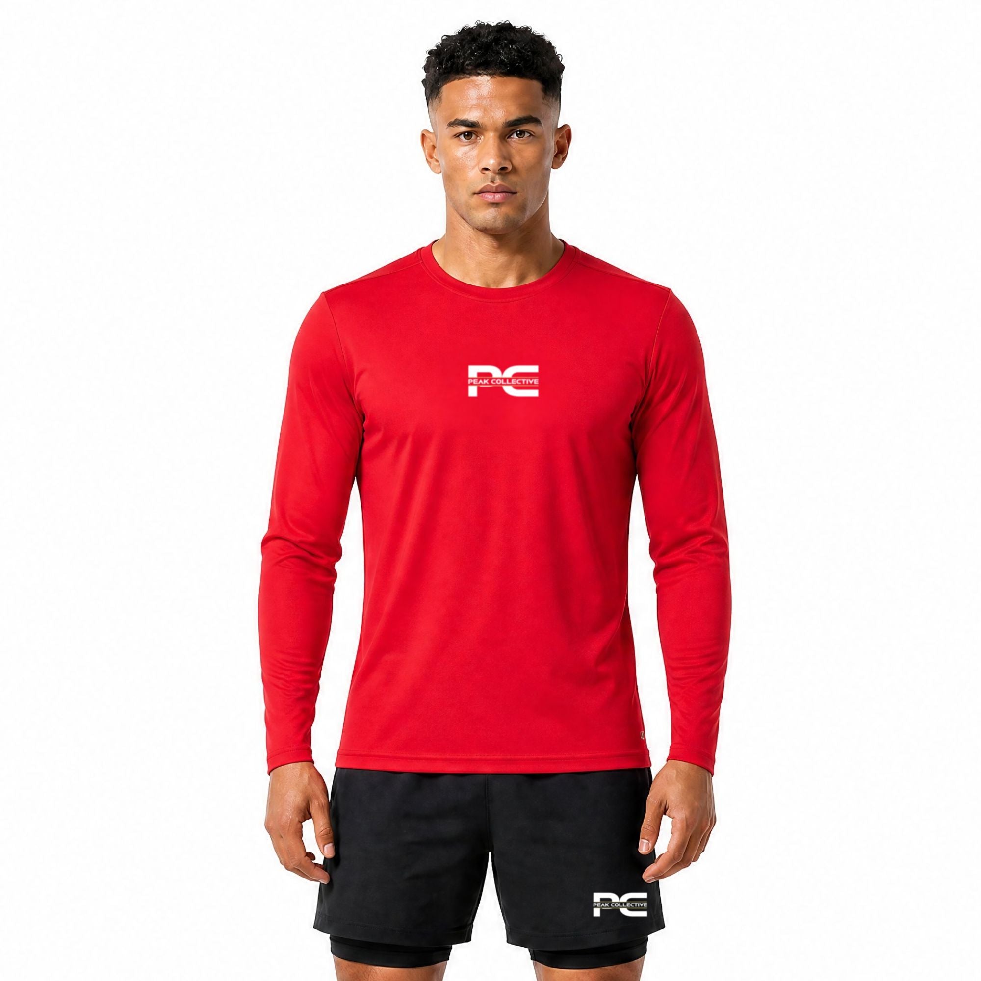 Male model wearing Red AeroSleeve long-sleeve performance top with visible logo on a white background – breathable men’s running shirt for training, gym workouts, jogging, and active performance wear. Outfit is paired with StrideShorts double layer running shorts.
