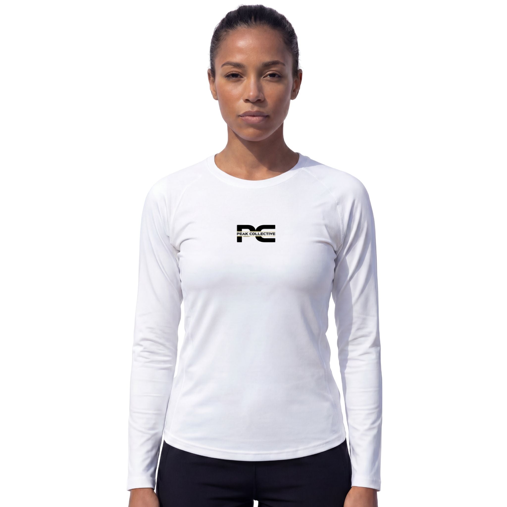 Female model wearing AuraSleeve white long-sleeve performance top with visible Peak Collective logo on white background – lightweight moisture-wicking women’s running shirt for training, running, jogging, gym workouts, and active performance wear