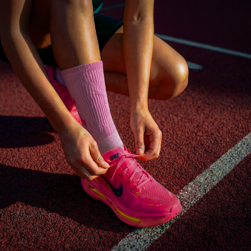 Model wearing CoreSteppers performance socks in Energy Pink, the socks are suitable for running, gym and outdoor activities