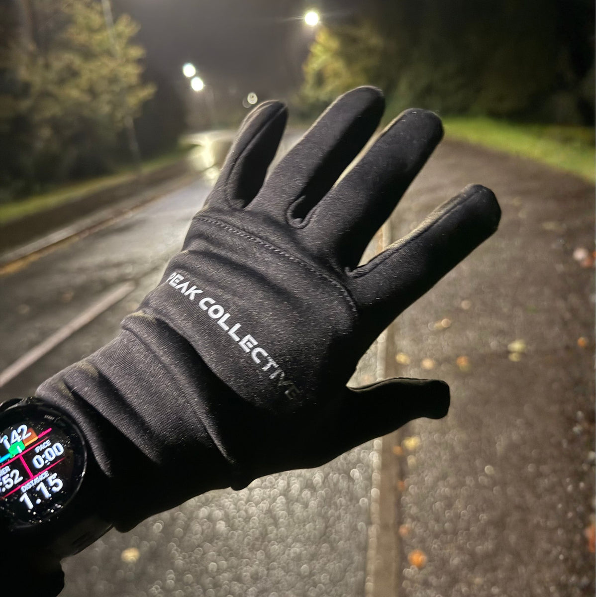 Runner wearing grey Peak Collective FrostGuard gloves outdoors during a run