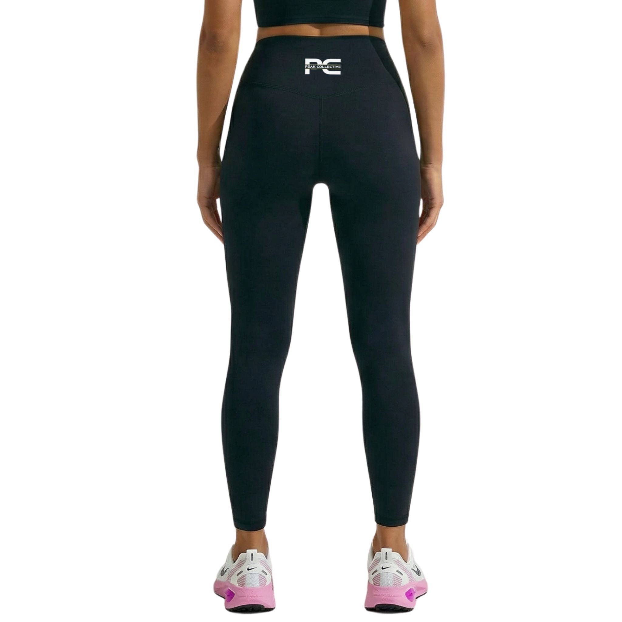 Back view of a person wearing black LumaLeggings women’s performance leggings with Peak Collective logo on a clean white background, designed for running, gym training, yoga, and everyday activewear