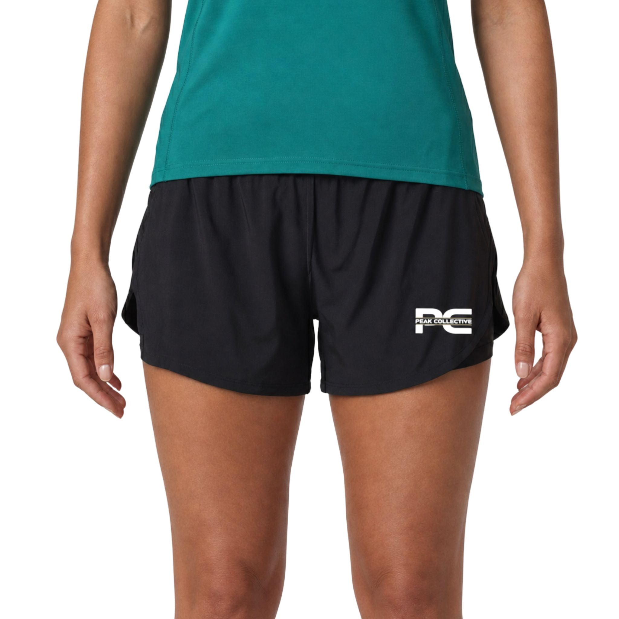Woman wearing black LumaShorts women’s performance athletic 2 layer shorts with Peak Collective logo on white background – lightweight running shorts for gym training, jogging, fitness workouts, and everyday activewear use