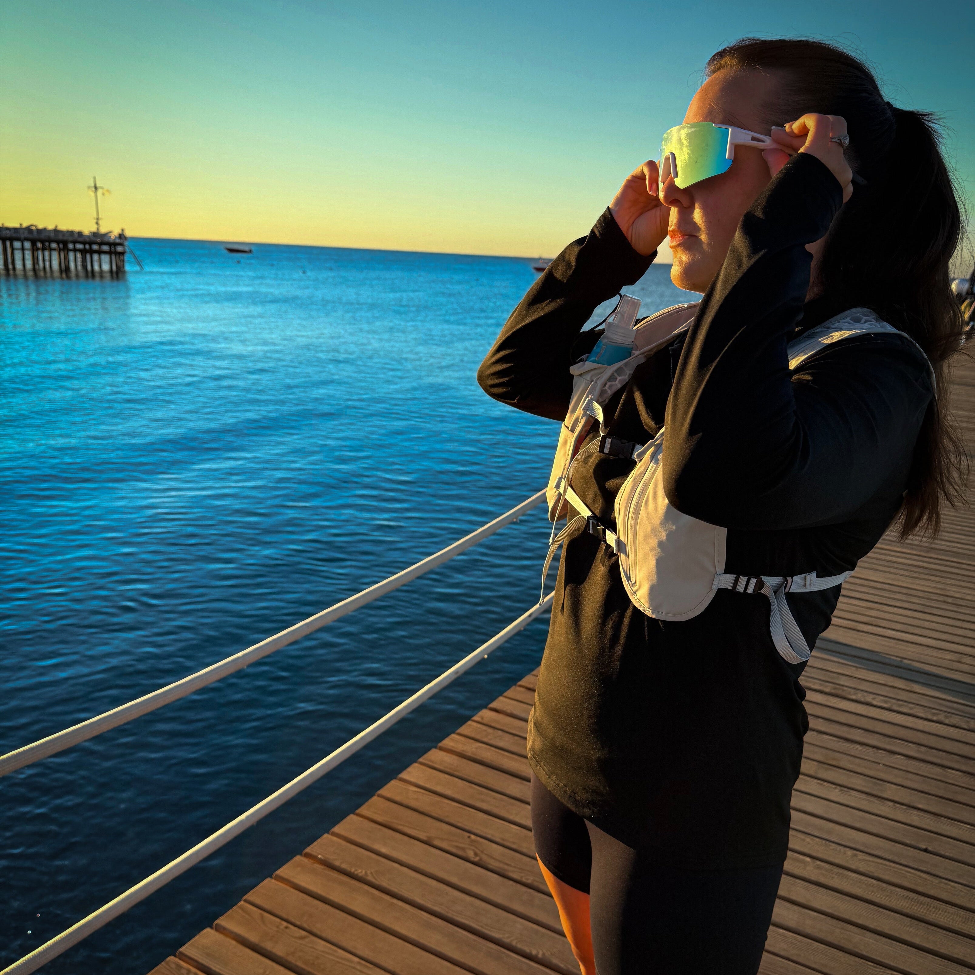 Female runner wearing StormLens performance glasses for running and outdoor sporting activities.