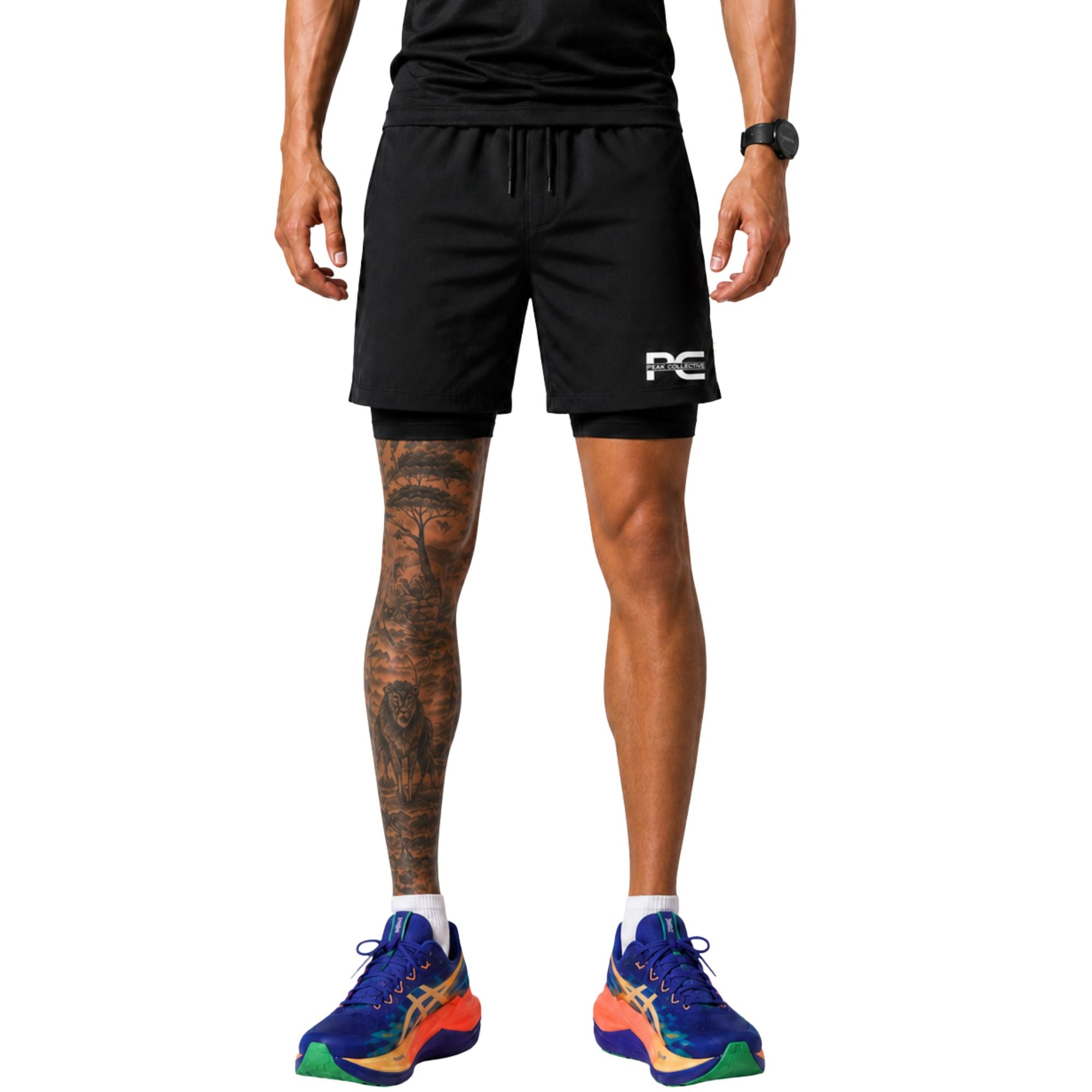 Man wearing black StrideShorts athletic double layer shorts with logo and colourful running shoes on white background – lightweight men’s running shorts for gym workouts, training, jogging, and activewear performance