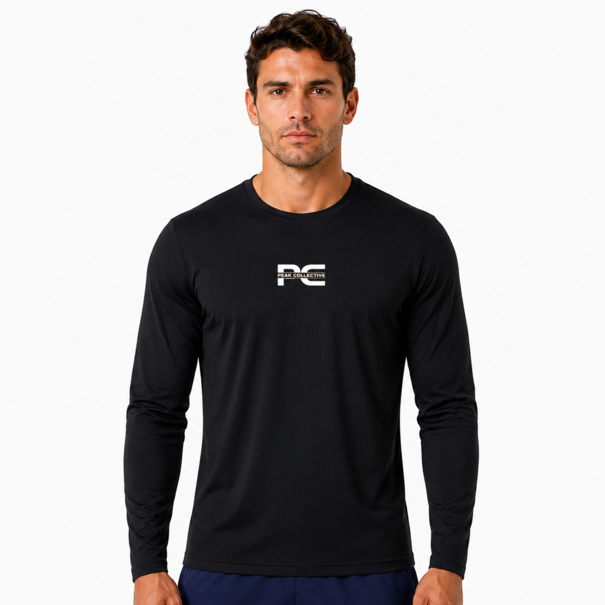 Male model wearing black AeroSleeve long-sleeve performance shirt with logo on white background – lightweight men’s running top for training, gym workouts, jogging, and activewear performance