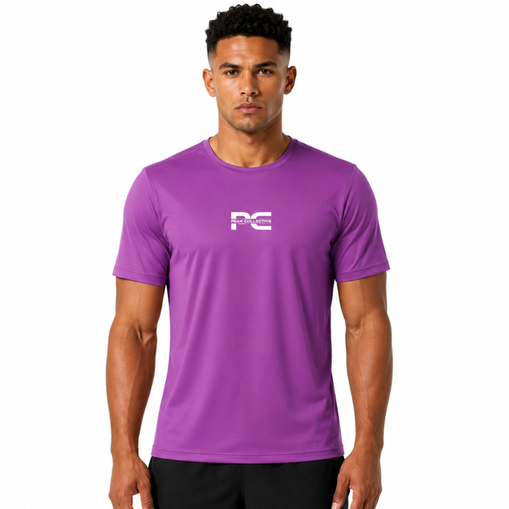Male model wearing purple AeroTee Sapphire short-sleeve performance shirt with logo on white background – lightweight men’s running top for gym workouts, training, jogging, and activewear performance