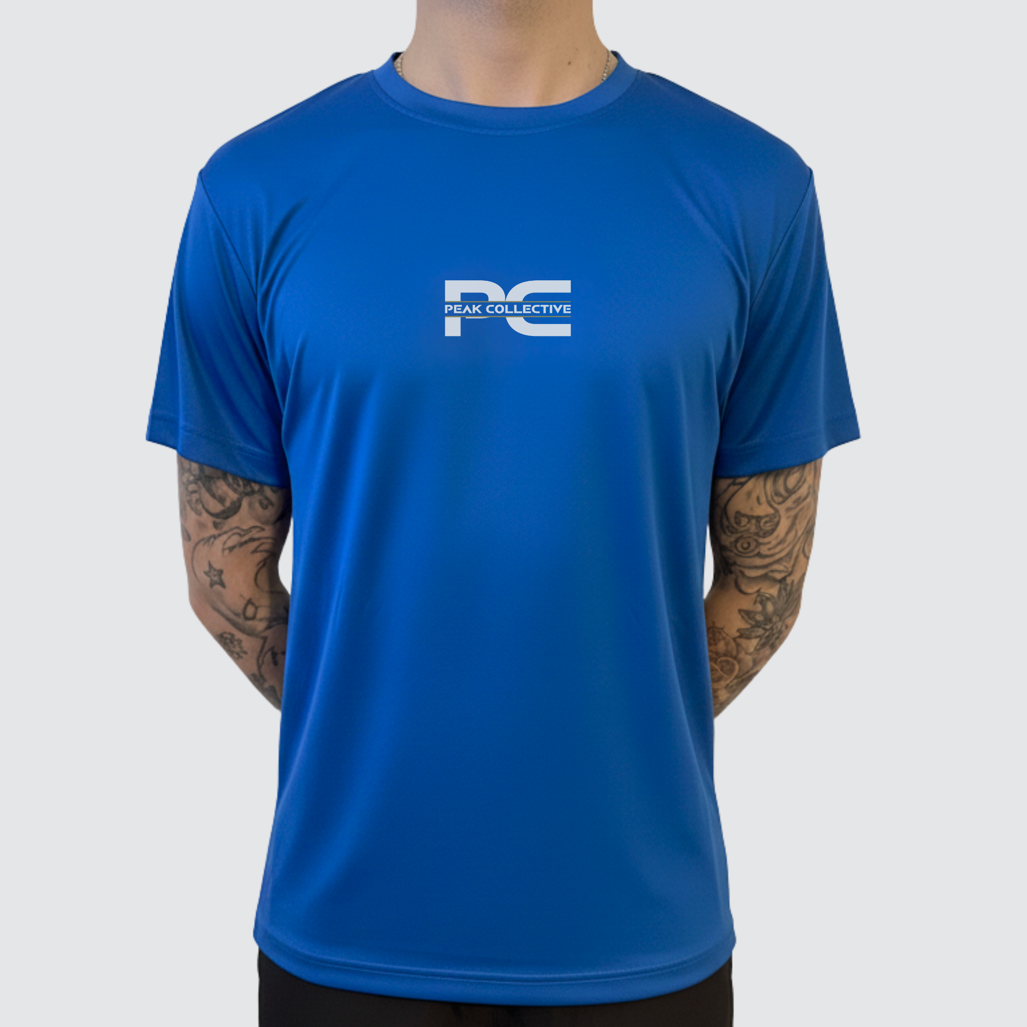 Person wearing AeroTee short sleeve performance top in blue with a visible logo on a white background, designed for running, training, and active wear.