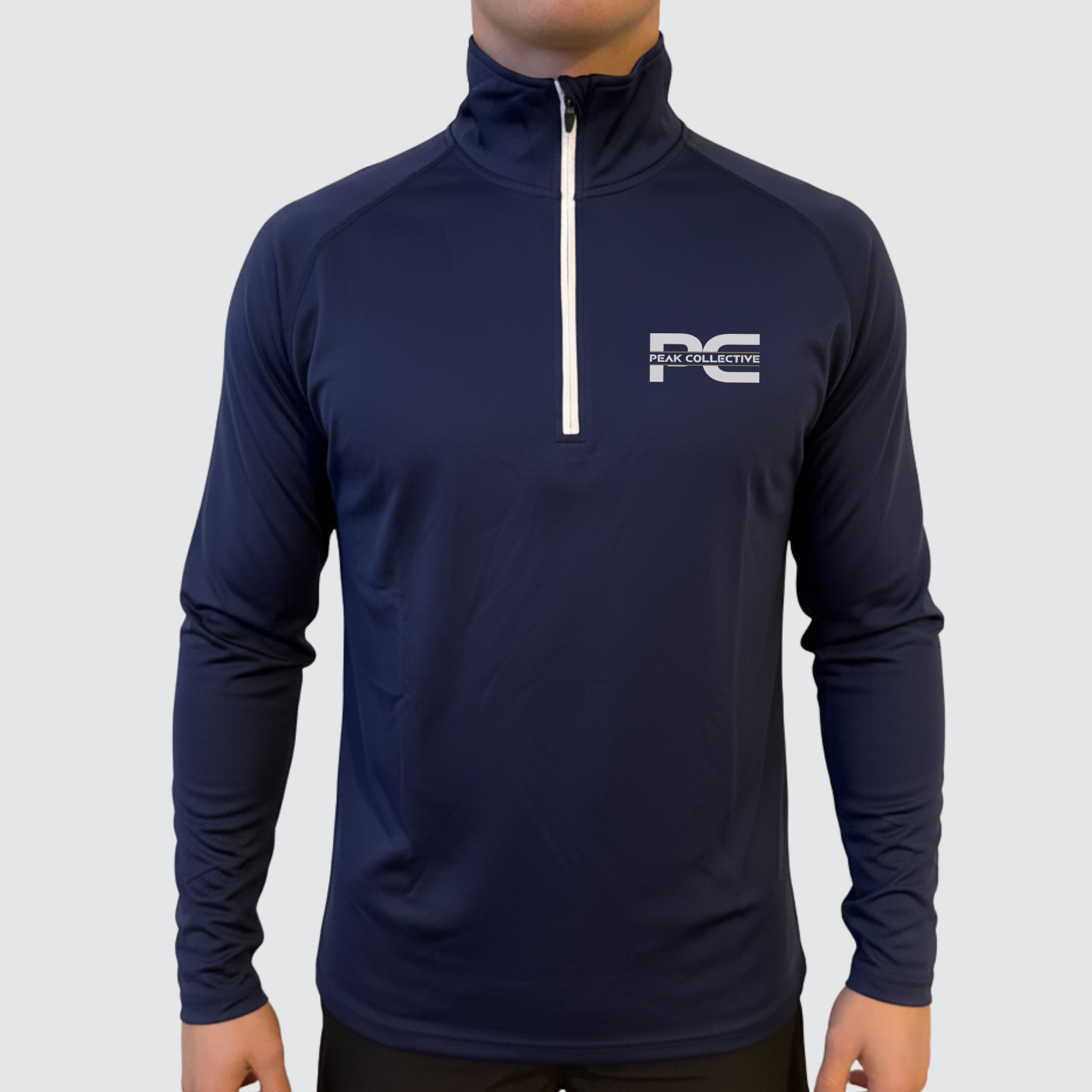 Model wearing AeroZip 1/4 long sleeve performance jacket in navy with a visible logo on a grey background, designed for running, training, and active wear.