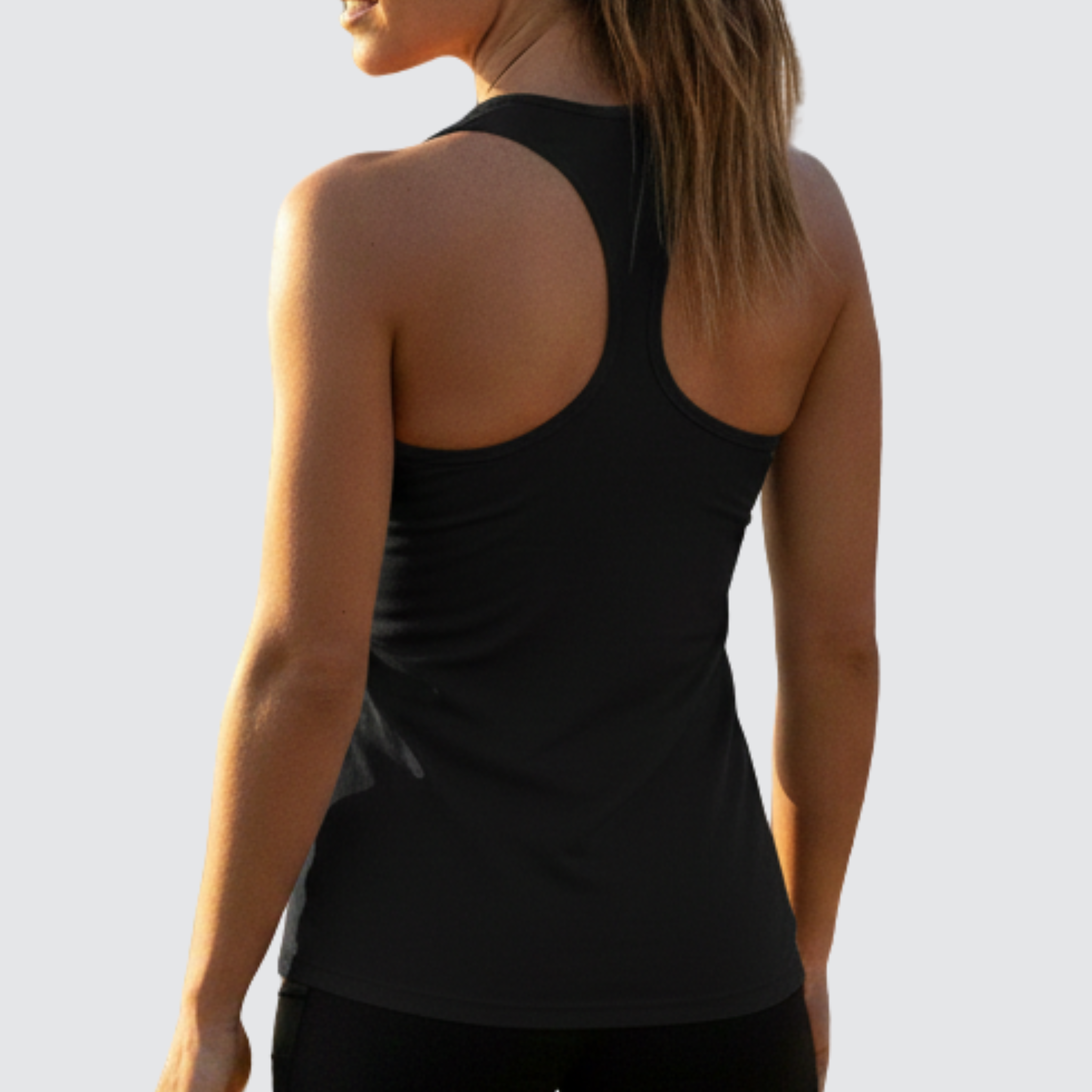 Person wearing AuraVest women’s performance vest in black with their back to the camera. Displayed on a light background, designed for training, running, workouts, and active movement.
