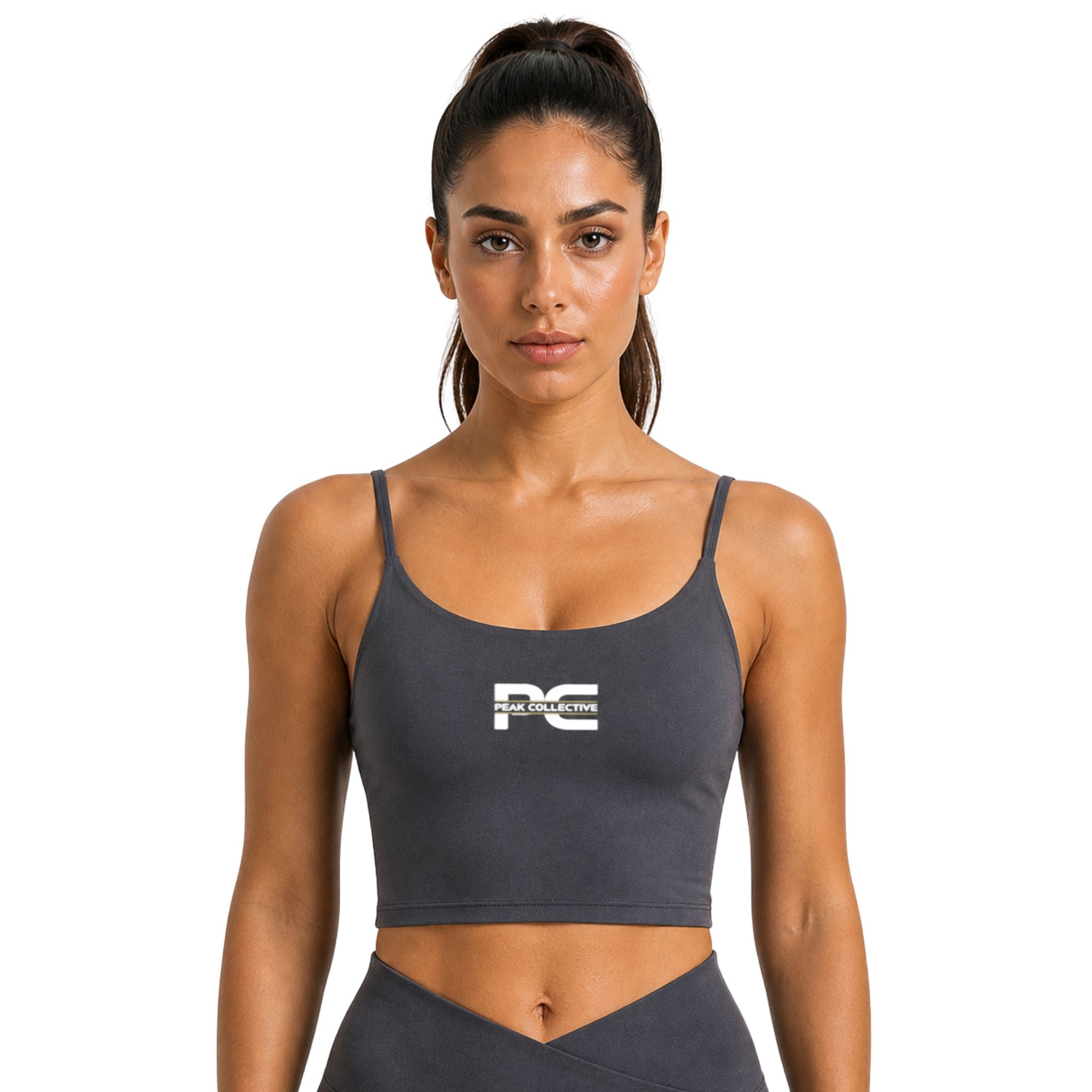 Woman wearing dark grey LumaCrop sports bra with logo on white background – supportive women’s performance crop top for running, gym workouts, yoga, training sessions, and everyday activewear