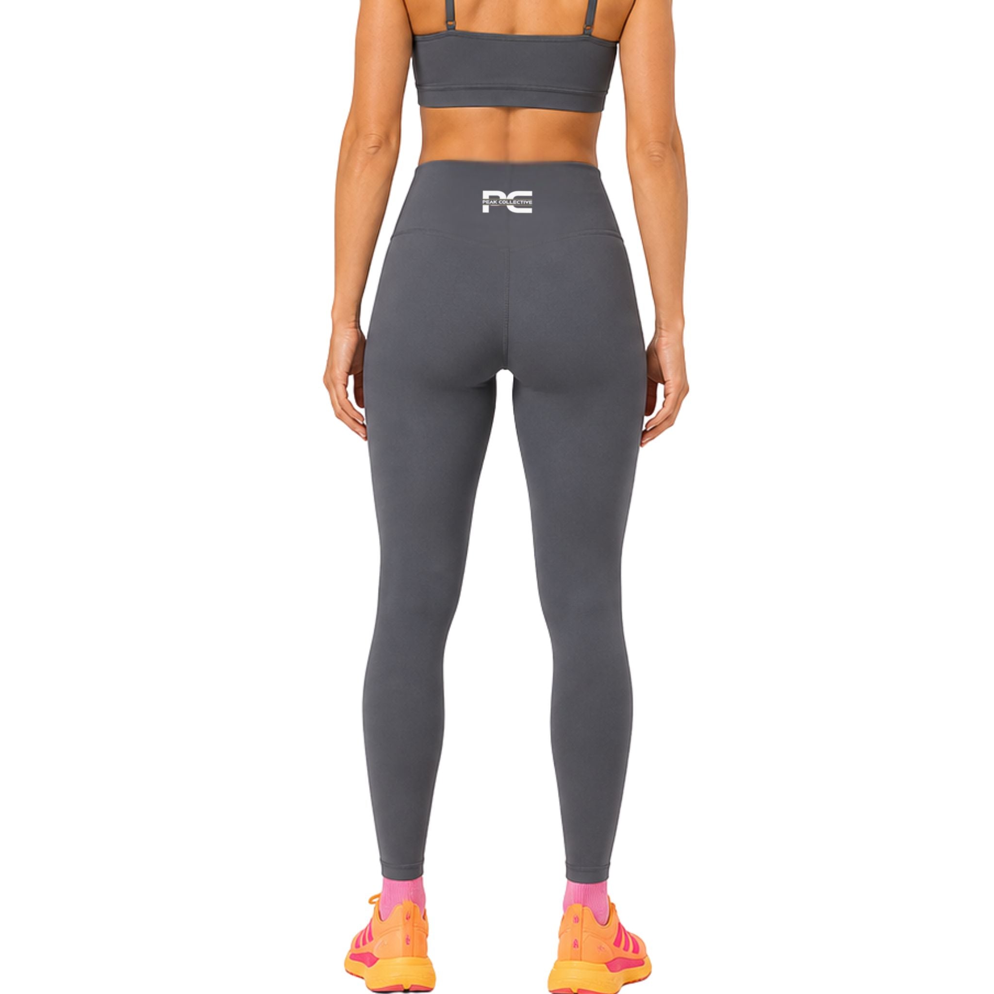 Back view of grey LumaLeggings women’s performance leggings with Peak Collective logo on white background – high-waisted women’s activewear leggings for running, gym training, yoga workouts, fitness, and everyday wear