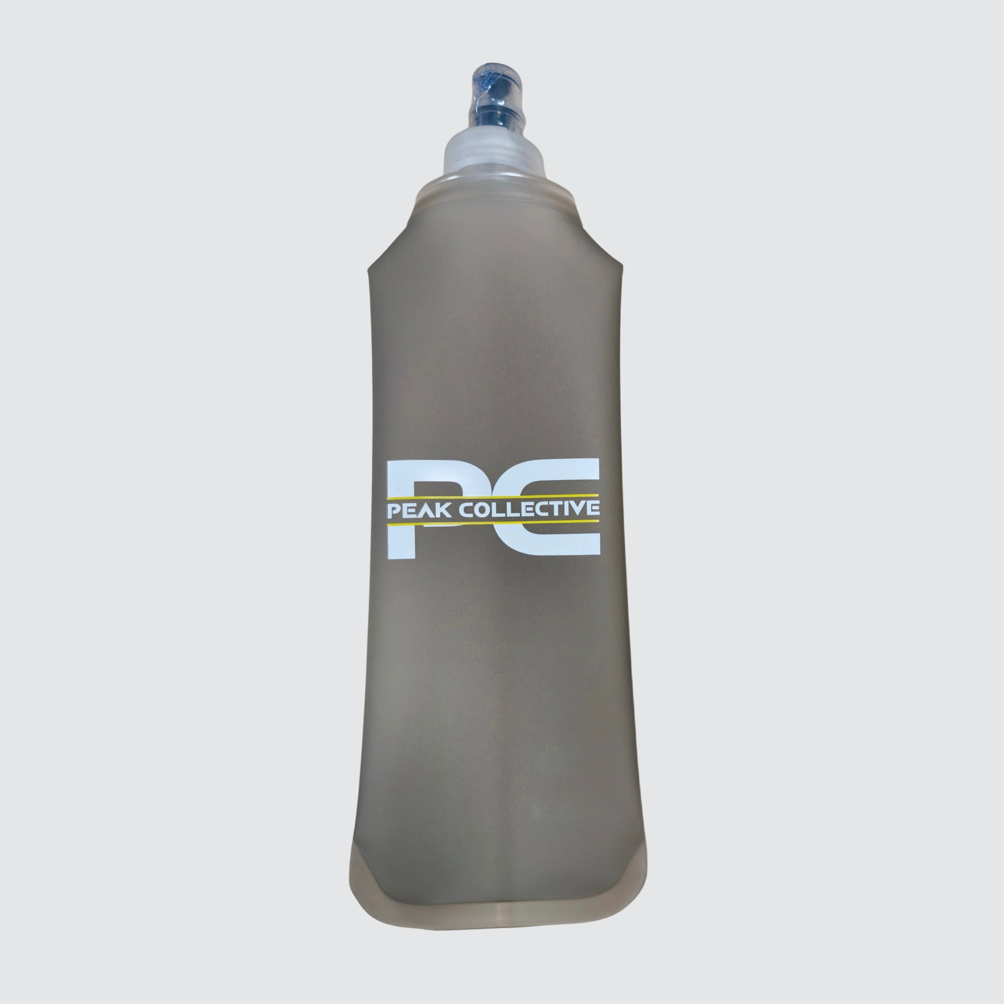 Grey PeakHydra soft running water bottle with Peak Collective logo on a white background, designed for lightweight hydration during running, training, and outdoor activity.