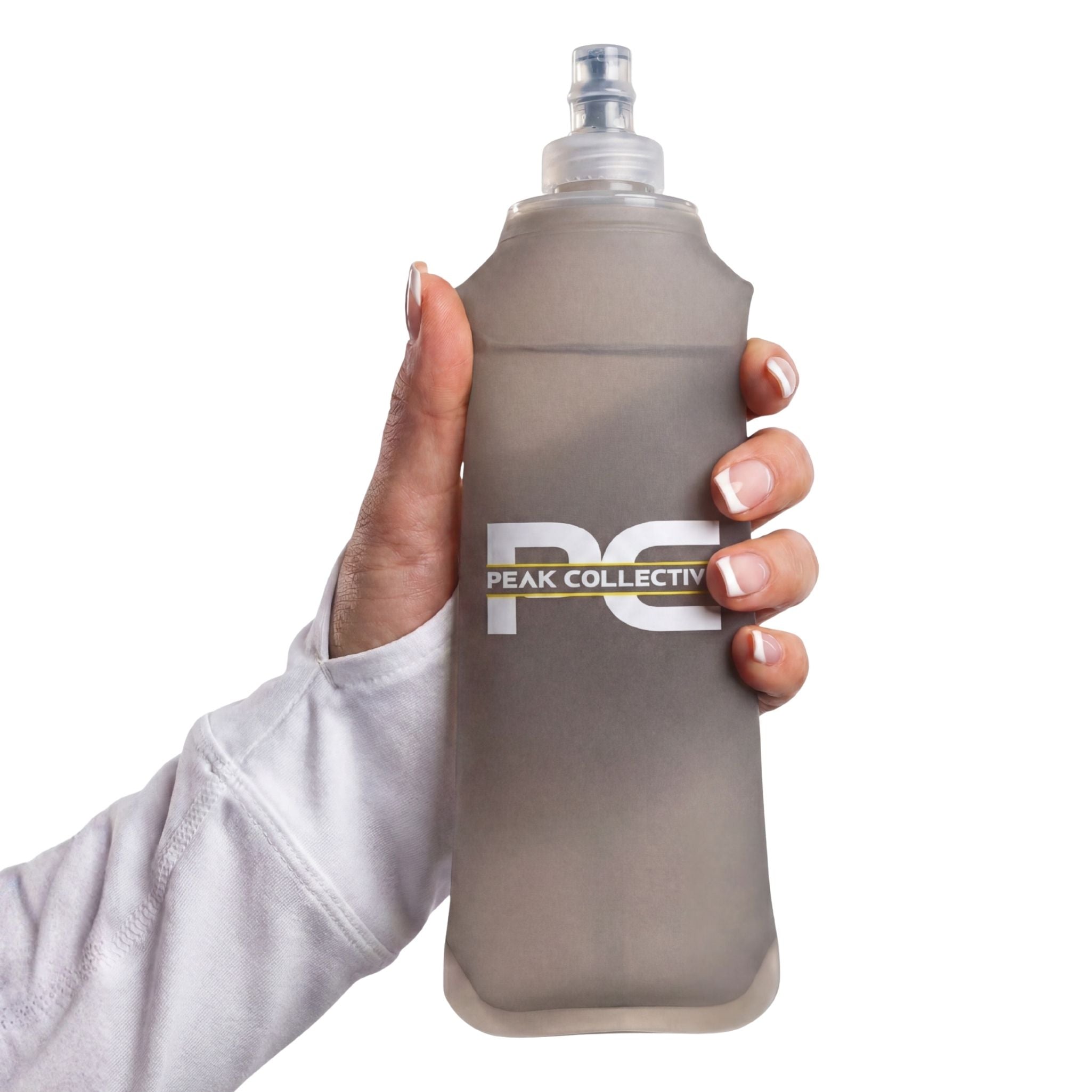 Hand holding PeakHydra soft flex water bottle from a front view 
