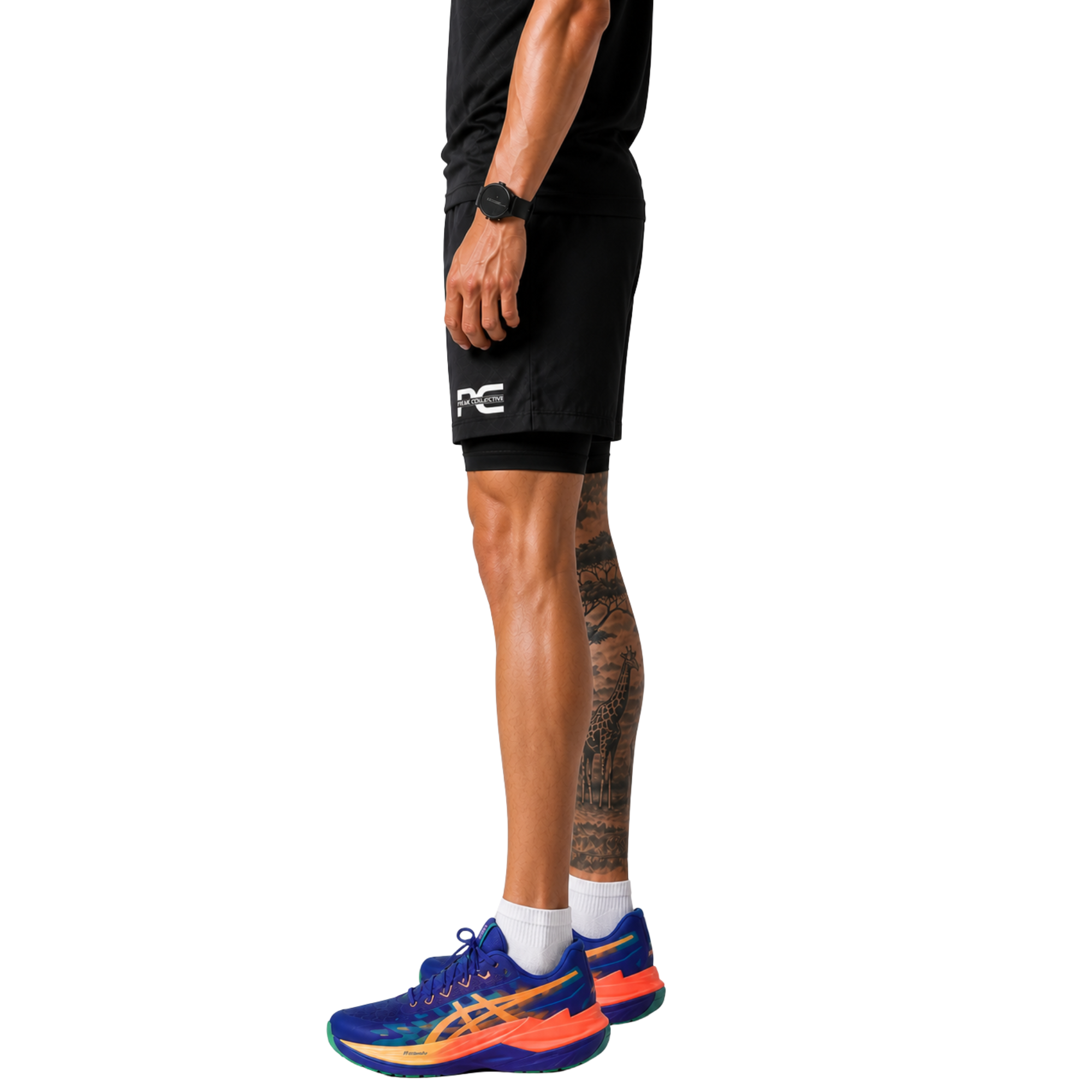 Side view of man wearing black StrideShorts double-layer athletic shorts with built-in undershorts, logo, and colourful running shoes on white background – lightweight men’s running shorts for gym workouts, training, jogging, and activewear performance